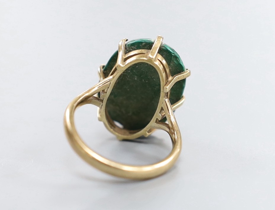 A 9ct gold and malachite set oval ring, size P/Q and a pair of similar earrings, gross weight 20.4 grams.